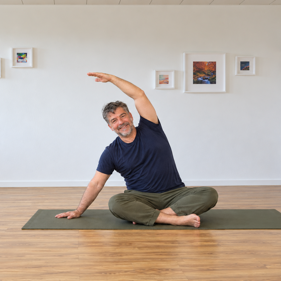 Cestiel Conte zeigt eine seitliche Dehnung im Sitzen auf der Yogamatte.